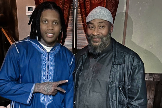 rapper Lil Durk at a Chicago mosque, surrounded by members of the Muslim community, with a prayer rug in the foreground.